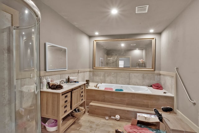 bathroom with vanity and separate shower and tub