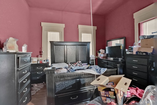 bedroom with dark wood-type flooring