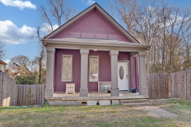 view of front of home with an outbuilding and a front lawn