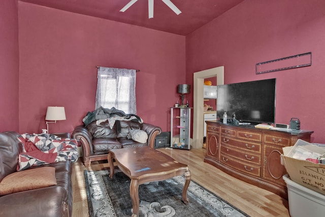 living room with light hardwood / wood-style flooring and ceiling fan