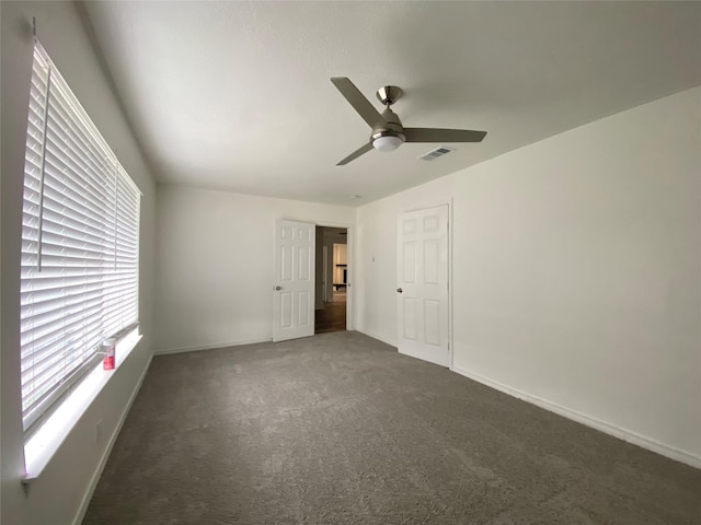 carpeted empty room featuring ceiling fan