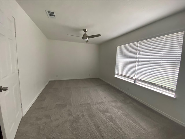 carpeted empty room featuring ceiling fan