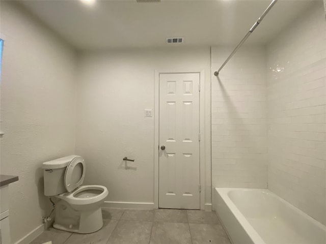 bathroom featuring tile patterned floors, shower / bathtub combination, and toilet