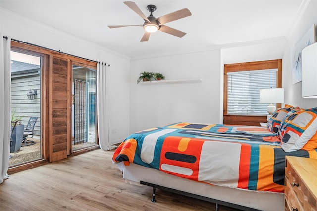 bedroom featuring ceiling fan, ornamental molding, and multiple windows