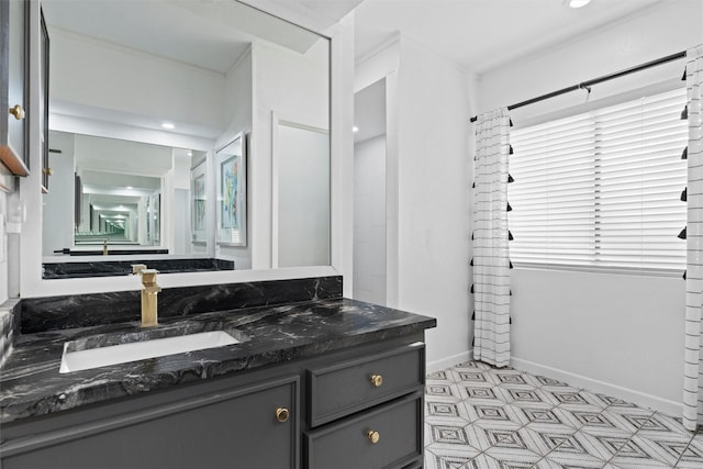 bathroom featuring vanity, tile patterned floors, and baseboards