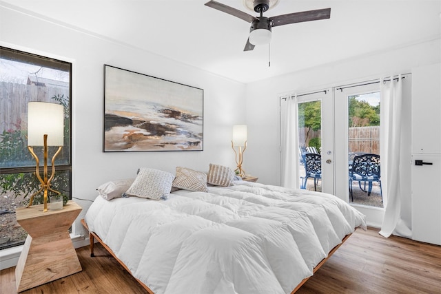 bedroom with hardwood / wood-style flooring, ceiling fan, access to outside, and french doors