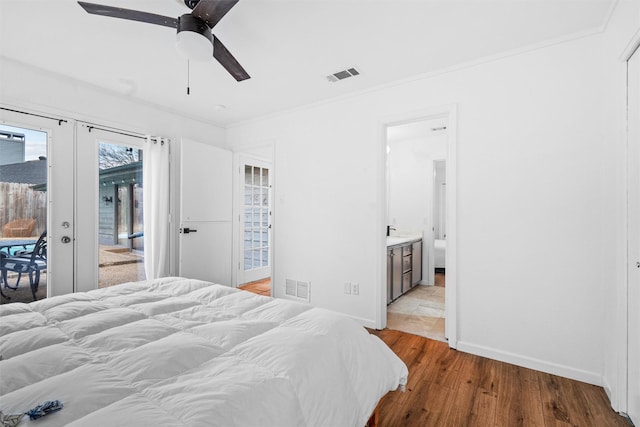 bedroom with access to outside, french doors, ensuite bathroom, ceiling fan, and light wood-type flooring