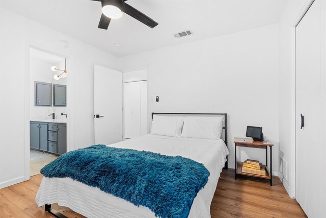 bedroom featuring ceiling fan, ensuite bathroom, and wood-type flooring