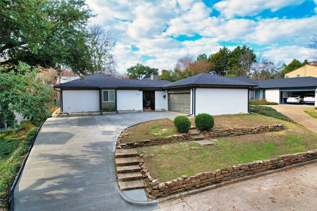 single story home featuring a front yard and a garage