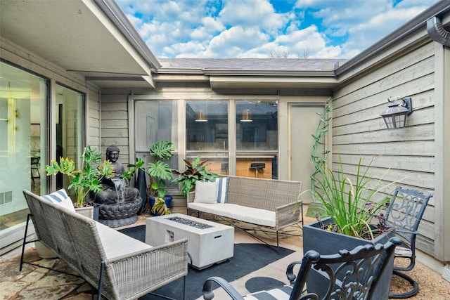 view of patio featuring an outdoor living space with a fire pit