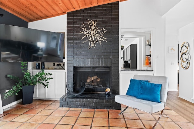 living area featuring lofted ceiling, a fireplace, a notable chandelier, and wood ceiling