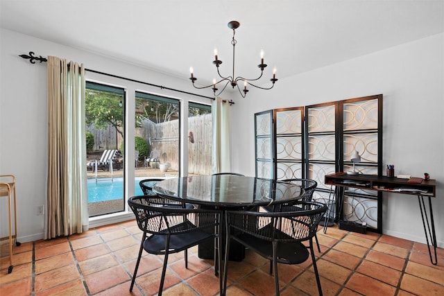 dining space with light tile patterned flooring, a notable chandelier, and baseboards