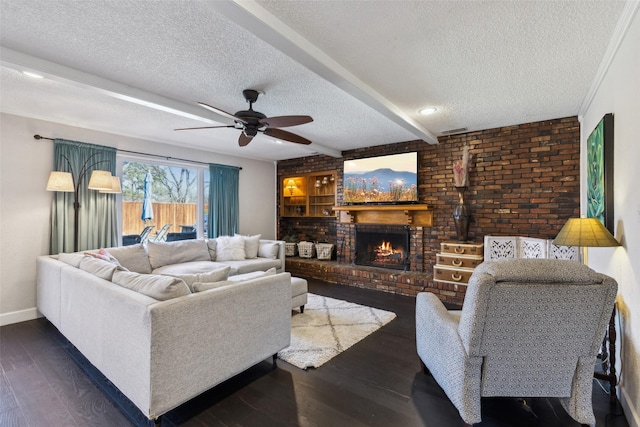 living room featuring ceiling fan, a brick fireplace, beamed ceiling, dark hardwood / wood-style floors, and a textured ceiling