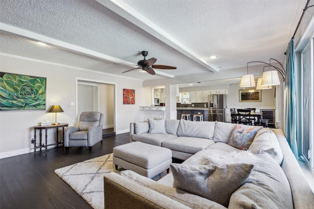 living room featuring ceiling fan, beamed ceiling, dark hardwood / wood-style floors, and a textured ceiling