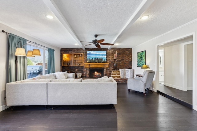 living room featuring brick wall, a textured ceiling, crown molding, a fireplace, and dark hardwood / wood-style floors