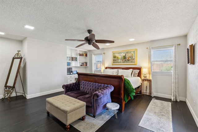 bedroom with ceiling fan, dark hardwood / wood-style flooring, and a textured ceiling