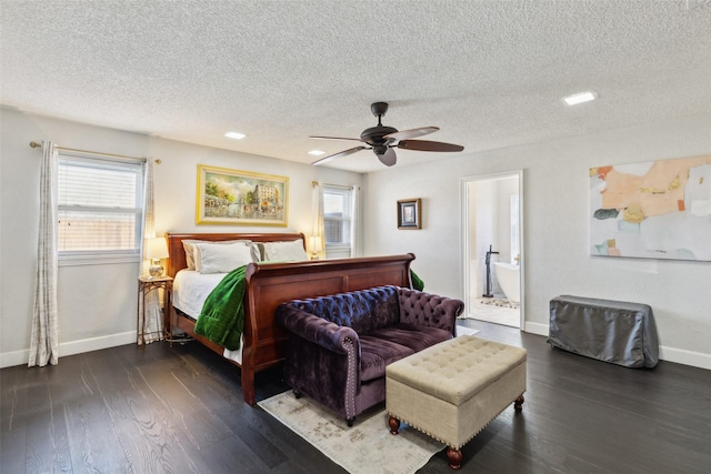 bedroom featuring a textured ceiling, ensuite bath, ceiling fan, and multiple windows