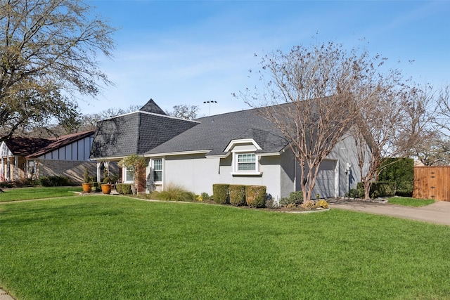 view of front of home with a garage and a front lawn