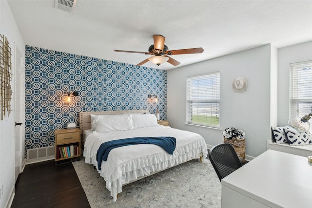 bedroom with ceiling fan and dark wood-type flooring