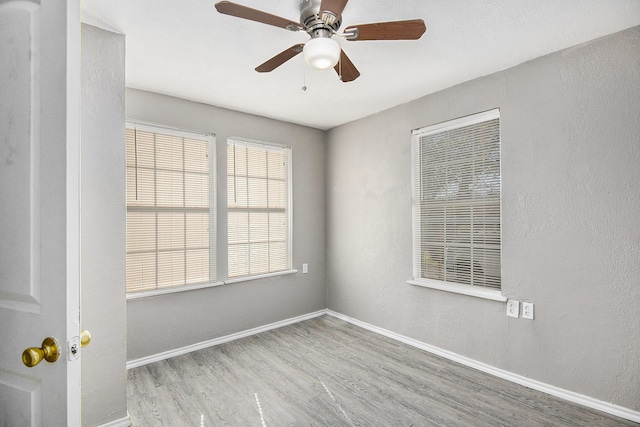 unfurnished room featuring ceiling fan and light wood-type flooring