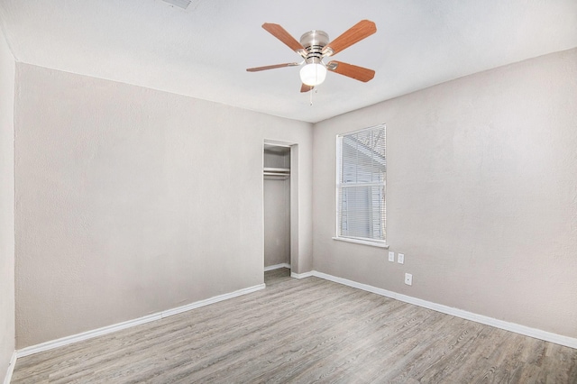 unfurnished bedroom featuring a closet, ceiling fan, and light wood-type flooring