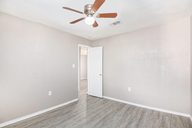 unfurnished room with ceiling fan and light wood-type flooring