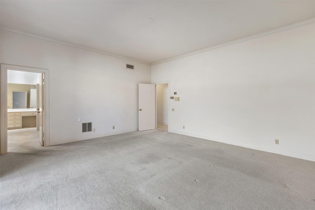 carpeted spare room featuring ornamental molding