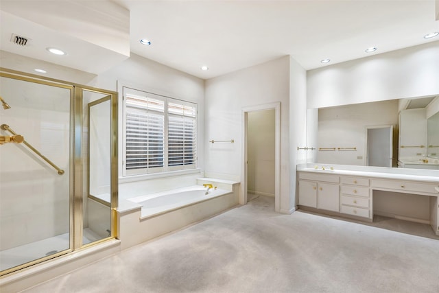 bathroom with vanity and shower with separate bathtub