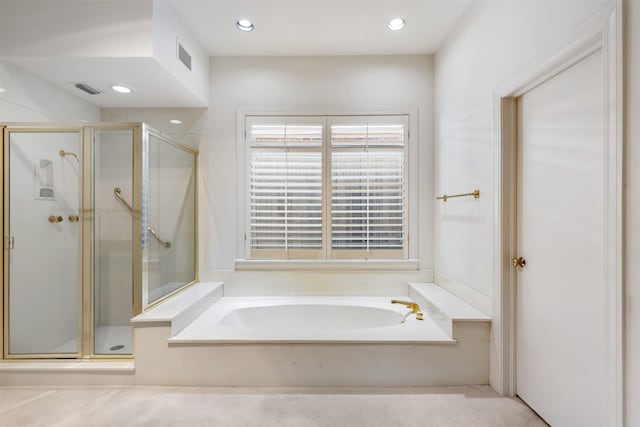 bathroom featuring shower with separate bathtub