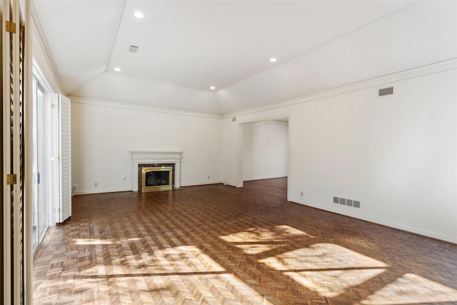 unfurnished living room featuring crown molding, lofted ceiling, a high end fireplace, and parquet flooring