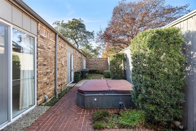 exterior space with a hot tub