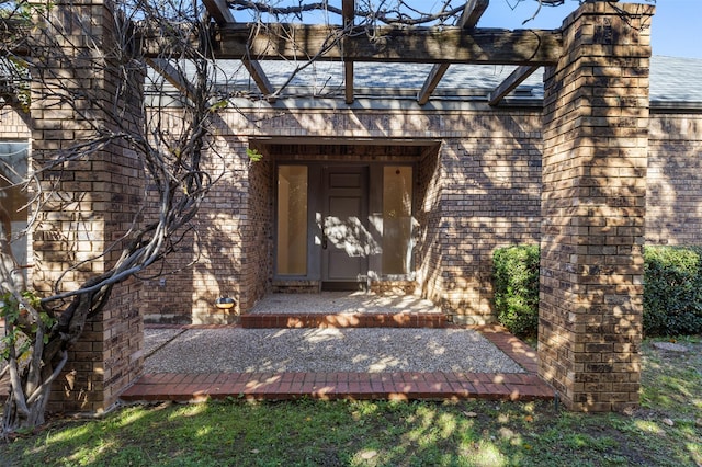 view of exterior entry featuring a patio