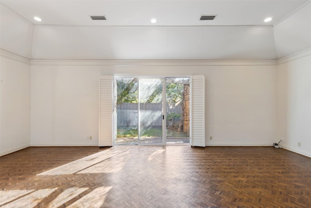 empty room featuring lofted ceiling, ornamental molding, and dark parquet floors