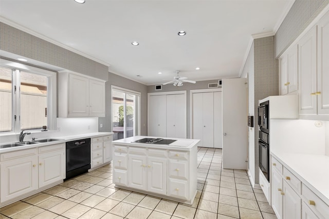 kitchen featuring white cabinetry, sink, a center island, black appliances, and crown molding