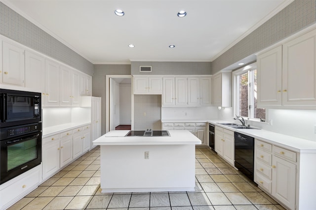 kitchen featuring white cabinetry, a kitchen island, crown molding, and black appliances