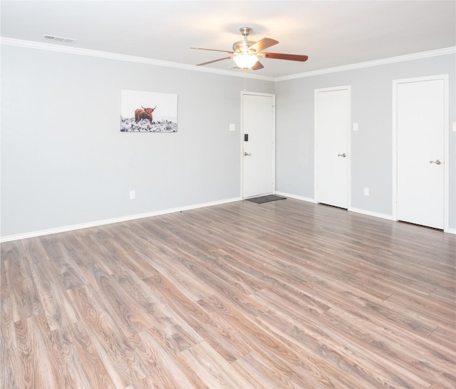 empty room featuring ornamental molding, ceiling fan, and light hardwood / wood-style flooring