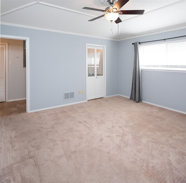 carpeted empty room featuring ornamental molding and ceiling fan