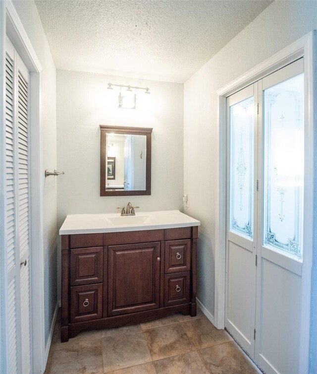 bathroom featuring vanity and a textured ceiling