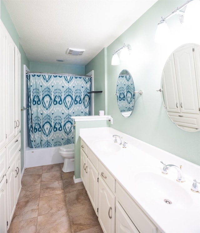 full bathroom featuring toilet, a textured ceiling, vanity, shower / bathtub combination with curtain, and tile patterned flooring