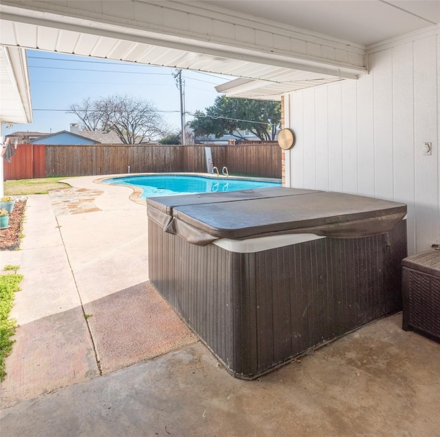 view of pool featuring a hot tub and a patio area