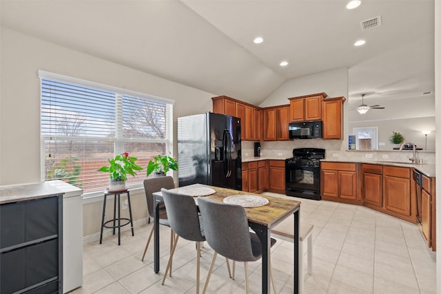 kitchen featuring decorative backsplash, ceiling fan, sink, black appliances, and lofted ceiling