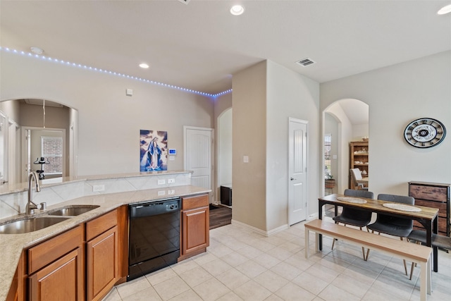 kitchen with sink, light tile patterned floors, and black dishwasher