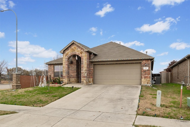 single story home with cooling unit, a garage, and a front lawn