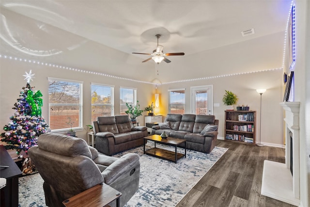 living room with ceiling fan and dark wood-type flooring