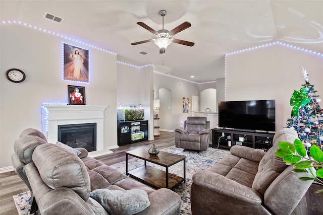 living room featuring hardwood / wood-style flooring and ceiling fan