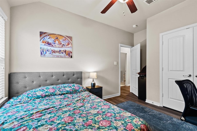 bedroom with ceiling fan, a closet, and dark wood-type flooring