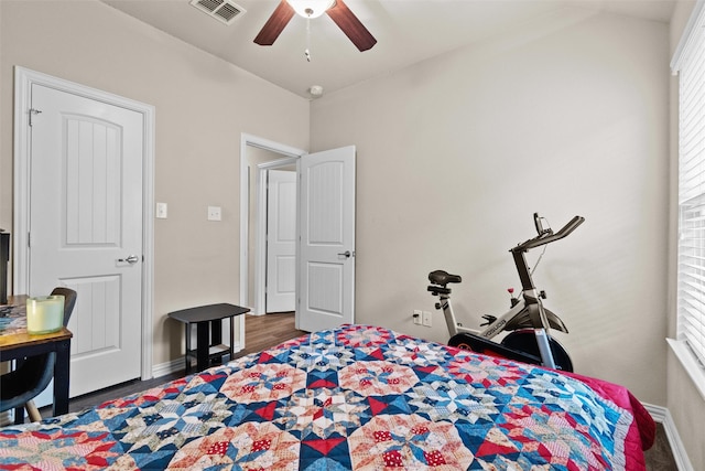 bedroom with ceiling fan and dark wood-type flooring