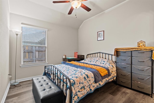 bedroom with hardwood / wood-style flooring, vaulted ceiling, and ceiling fan