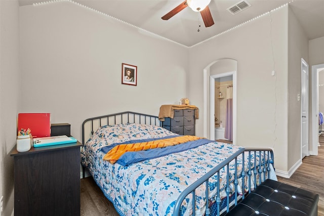 bedroom with ceiling fan, wood-type flooring, and connected bathroom