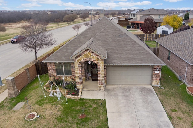 view of front of home with a garage and a front yard